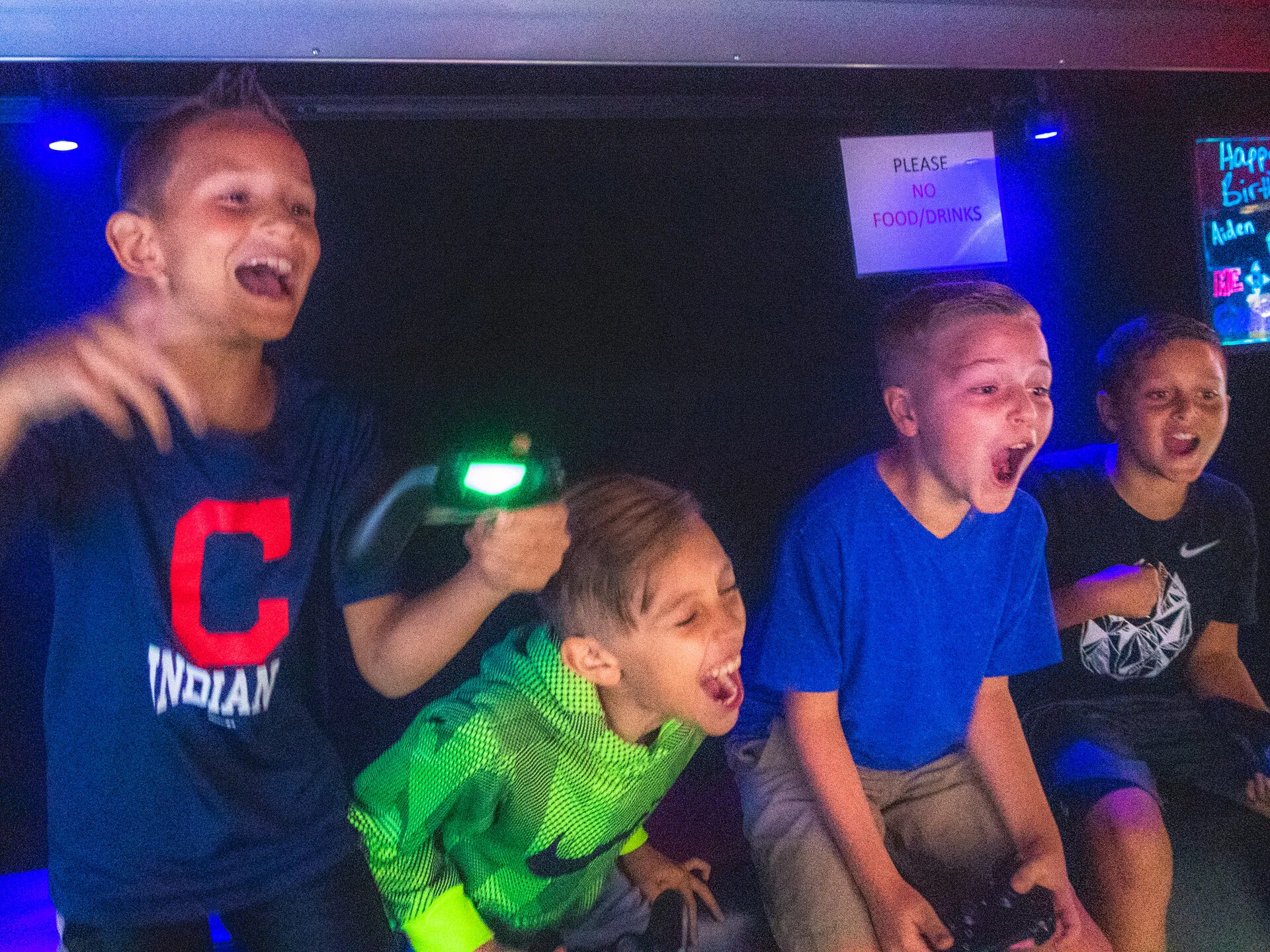 Kids cheering while playing video games inside the Me 2 You Game Truck